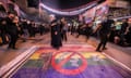 Shia Muslim devotees self-flagellate over an unfurled banner on the ground depicting the Pride rainbow flag defaced with a boot in the city of Nasiriyah in Iraq in 2023. 