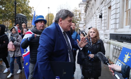 Home Office minister Kit Malthouse arrives for meeting in London surrounded by protesters.