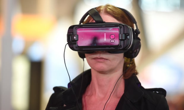 A woman uses a Samsung Gear VR virtual reality headset.
