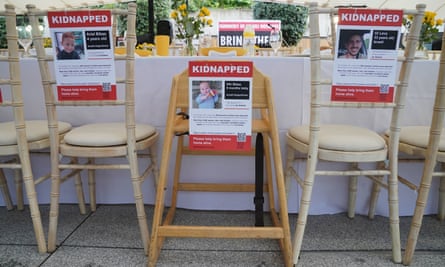 Empty chairs decorated with signs of missing people