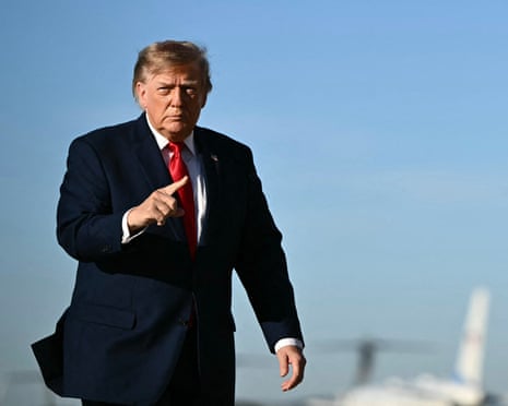Donald Trump points while walking outside