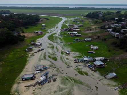 Houses and boats stranded along a dried-up Negro river
