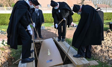 A coffin is put into a grave, at Pierrette cemetery in Bethune.