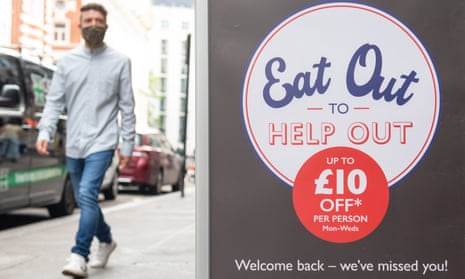 A man walks past an eat out to help out sign