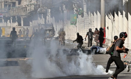 Iraqi riot police fire tear gas to disperse anti-government protesters.