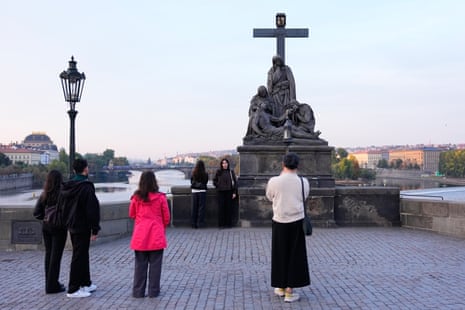 Two people recreating the Depeche Mode image as people watch nearby.