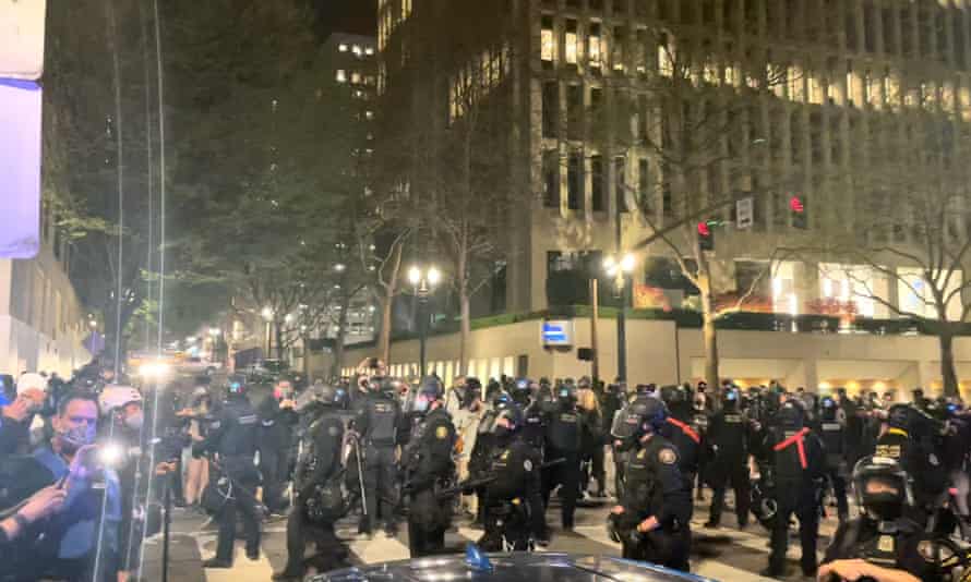 Riot police stand guard during protests in Portland, Oregon, on 16 April.
