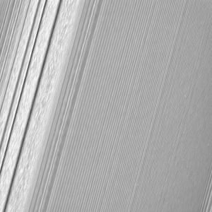 This image features a density wave in Saturn’s A ring (at left). Density waves are accumulations of particles at certain distances from the planet.