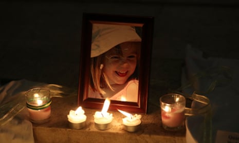Candles illuminate a photograph of Madeleine McCann inside the church of Praia da Luz, near Lagos in 2017.