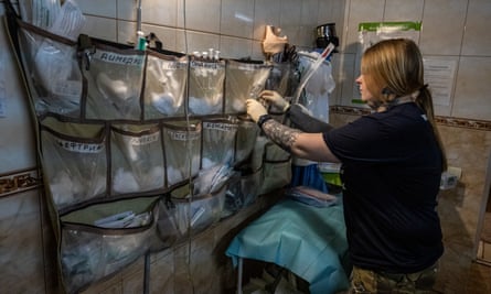 Ukrainian surgeon and nurse Valentyna fills syringes with painkillers as a Ukrainian armed forces brigade remains ready to receive casualties at a hidden stabilisation point in the Donetsk region on 27 April.