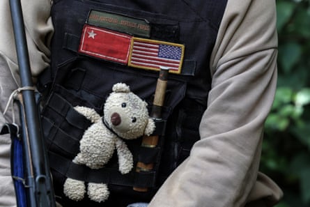 Close up of Anina’s bulletproof vest with a small white teddy bear tucked into it