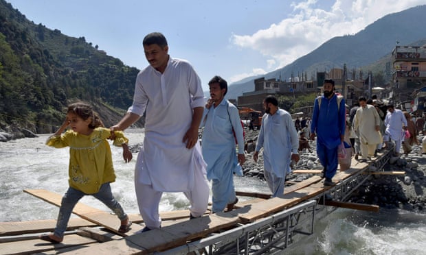 People cross makeshift bridge