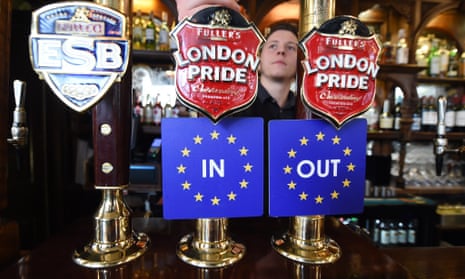 Bar coasters are pinned to ale taps at a pub in Westminster, London.