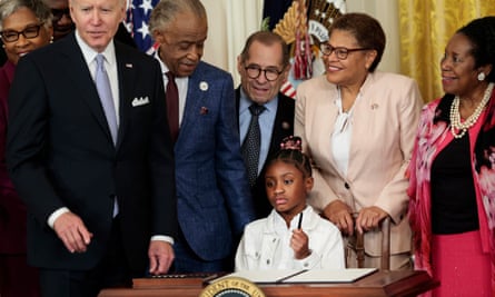 Gianna Floyd, the daughter of George Floyd, holds a pen used by Joe Biden to sign an executive order enacting further police reform in the East Room of the White House on 25 May 2022.