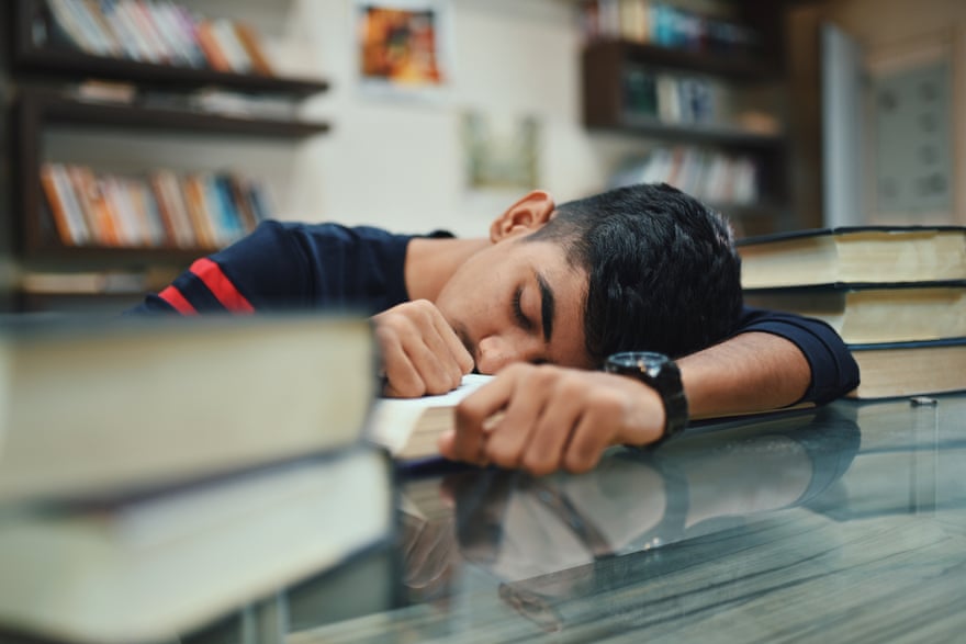boy sleeping in library