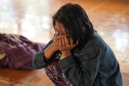 A mourner reacts as bodies are laid out at a cemetery before their burial following a Myanmar military air strike in Mrauk U in western Rakhine state on 11 December 2025.