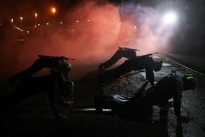 Trainees do push-ups during a smoke bomb simulation