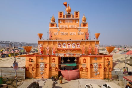 A multi-tiered orange structure with religious symbols and writing