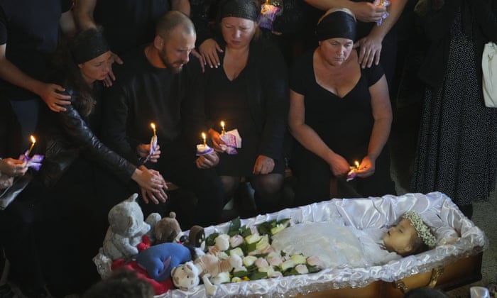 Relatives and friends pay their last respects to Liza, a 4-year-old girl killed by a Russian attack, during a mourning ceremony in an Orthodox church in Vinnytsia, Ukraine, Sunday, July 17, 2022. Wearing a blue denim jacket with flowers, Liza was among 23 people killed, including 2 boys aged 7 and 8, in Thursday’s missile strike in Vinnytsia. Her mother, Iryna Dmytrieva, was among the scores injured.