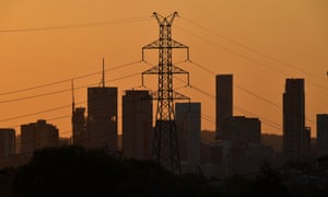 City skyline with electricity transmission tower