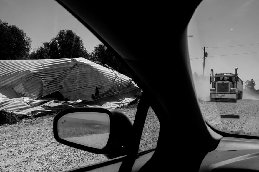A semi truck drives past a destroyed silo in Atkins, Iowa.