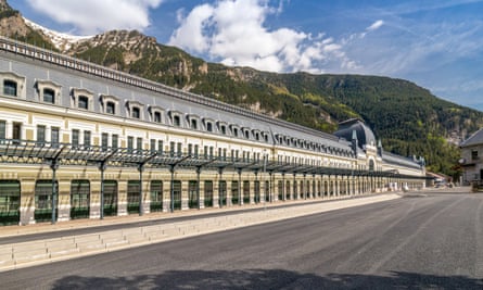 long station building with mountains behind