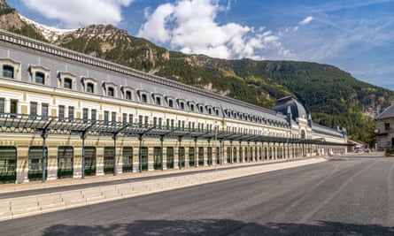 long station building with mountains behind