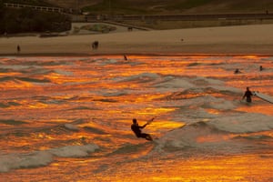A hazy red sun sets over Bondi Beach in Sydney, Australia. The NSW premier, Gladys Berejiklian, has declared a state of emergency for the next seven days with ongoing dangerous fire conditions and almost 100 bushfires burning across the state