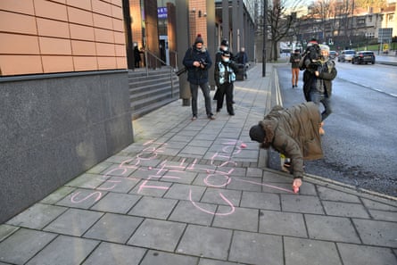Paula Richardson writing “Support the Colston 4” in chalk outside Bristol magistrates court