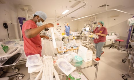 Hospital staff turn surgical theatres and recovery departments into intensive care wards for Covid 19 patients.