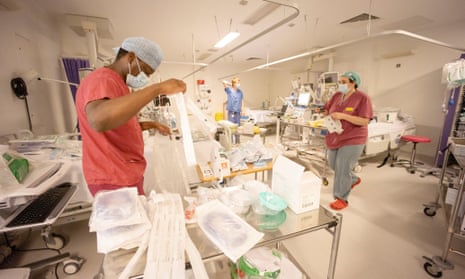 Hospital staff spend New Year’s Eve turning surgical theatres and recovery departments into intensive care wards for the influx of Covid-19 patients. 