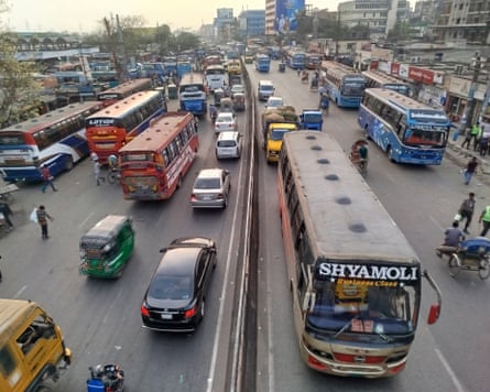 Lots of buses in different colours picking up passengers