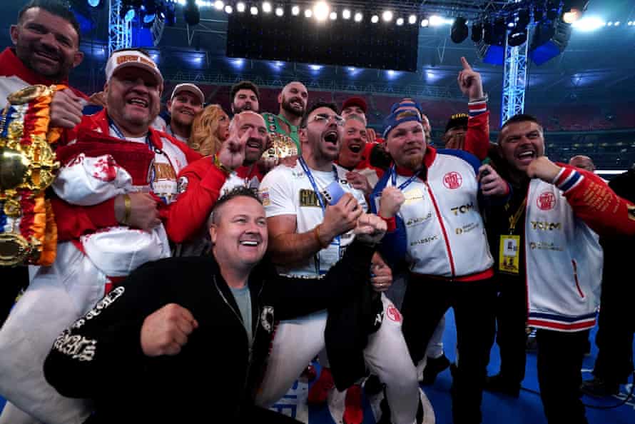 Tyson Fury (centre, rear) celebrates with his team after knocking down Dillian Whyte.
