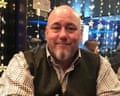 Bald and bearded man in brown waistcoat and brown checked shirt