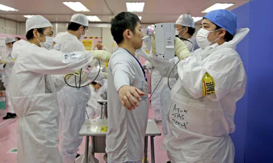 Fukushima workers are scanned for radiation exposure