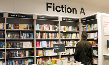 Man browsing fiction section of Waterstone’s bookshop