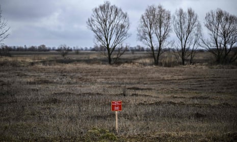 Sign reading 'danger: mines' in a wheat field, Ukraine