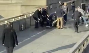 Steve Gallant, in the centre wearing a purple jumper, is crouched over the terrorist Usman Khan on London Bridge.