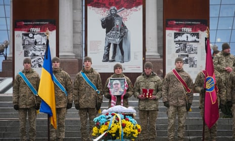 Ukrainian servicemen stand guard the coffin of their comrade Oleh Yurchenko killed in a battlefield with Russian forces in Donetsk region.