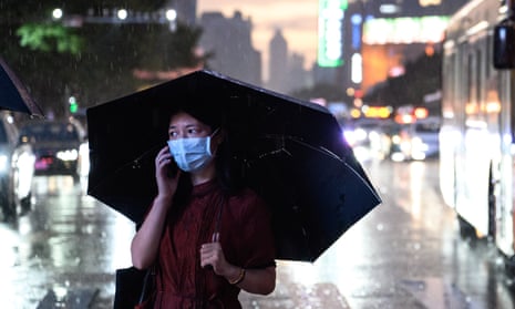 A woman walks under the rain as Typhoon Ma-on hits Guangzhou 