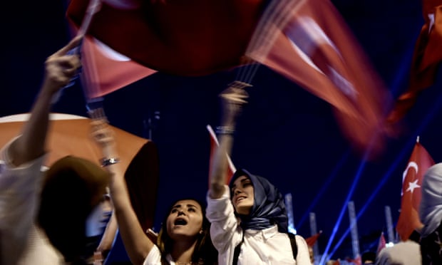 Pro-Erdoğan supporters wave Turkish national flags during a rally at Taksim square in Istanbul, several days after the failed coup.