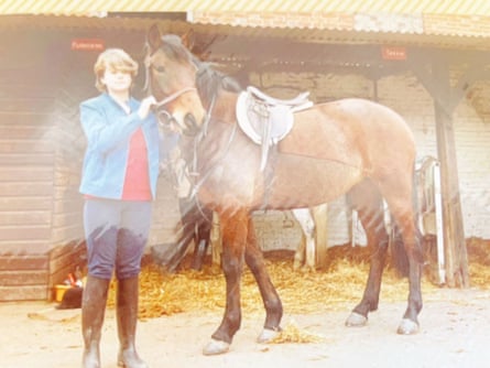 Tracy, the stepdaughter from his first marriage of crime writer Christopher Berry-Dee, pictured as a teenager, standing beside a horse