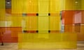 Yellow and orange silk strips hanging vertically and diagonally in a large space.