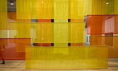 Yellow and orange silk strips hanging vertically and diagonally in a large space.