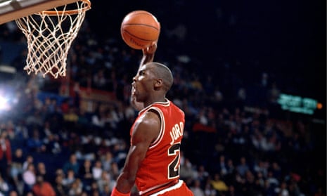 Michael Jordan of the Chicago Bulls dunks against Jeff Malone of the Washington Bullets in about 1990.
