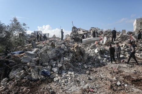 People inspect the rubble of a house where Israel claimed two Palestinian militants were killed during an Israeli security force raid in Burqin village near Jenin in the occupied West Bank.