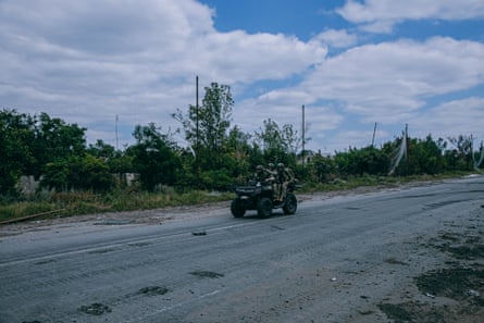 Soldiers driving on a buggy.