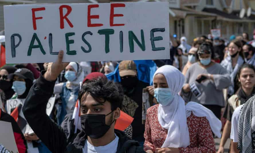 Protesters march through neighborhoods near the Ford Motor Company plant in Dearborn, Michigan, which Joe Biden visited on Tuesday.