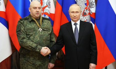 Vladimir Putin shakes hands with Sergei Surovikin in December 2022.