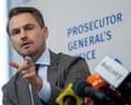 Ukraine's prosecutor general, Ruslan Kravchenko, gestures while speaking at microphones during a press conference